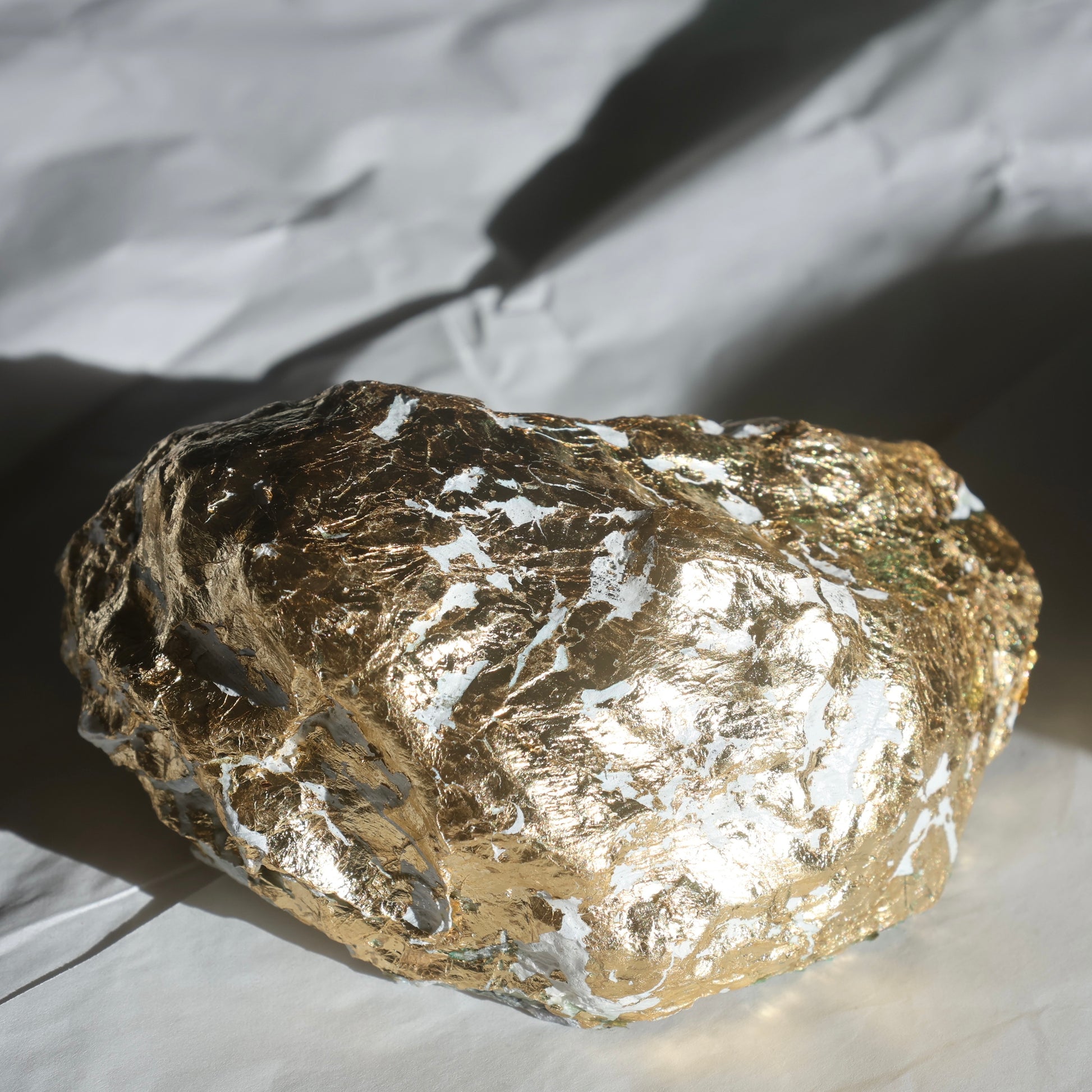 Back view of the oyster shell covered in bright gold foil by Lily Glow Home Decor