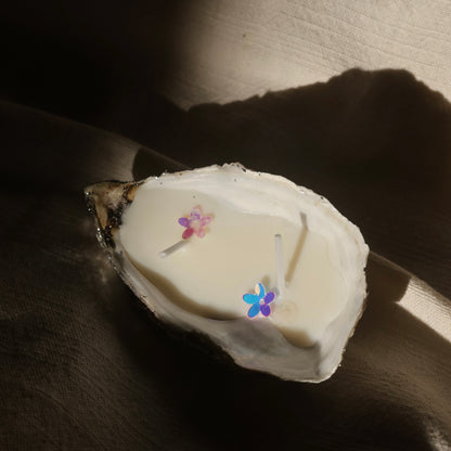 Seashell candle with glitter flowers and soft shadows by Lily Glow Home Decor