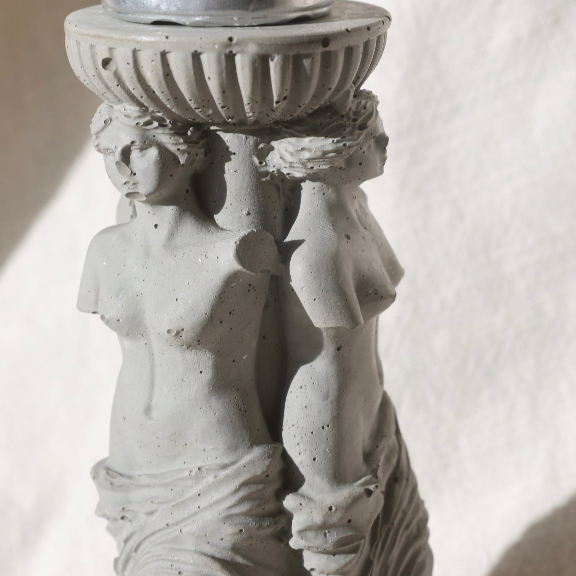 Close-up of sculptural details on Three Venuses candle holder by Lily Glow Home Decor