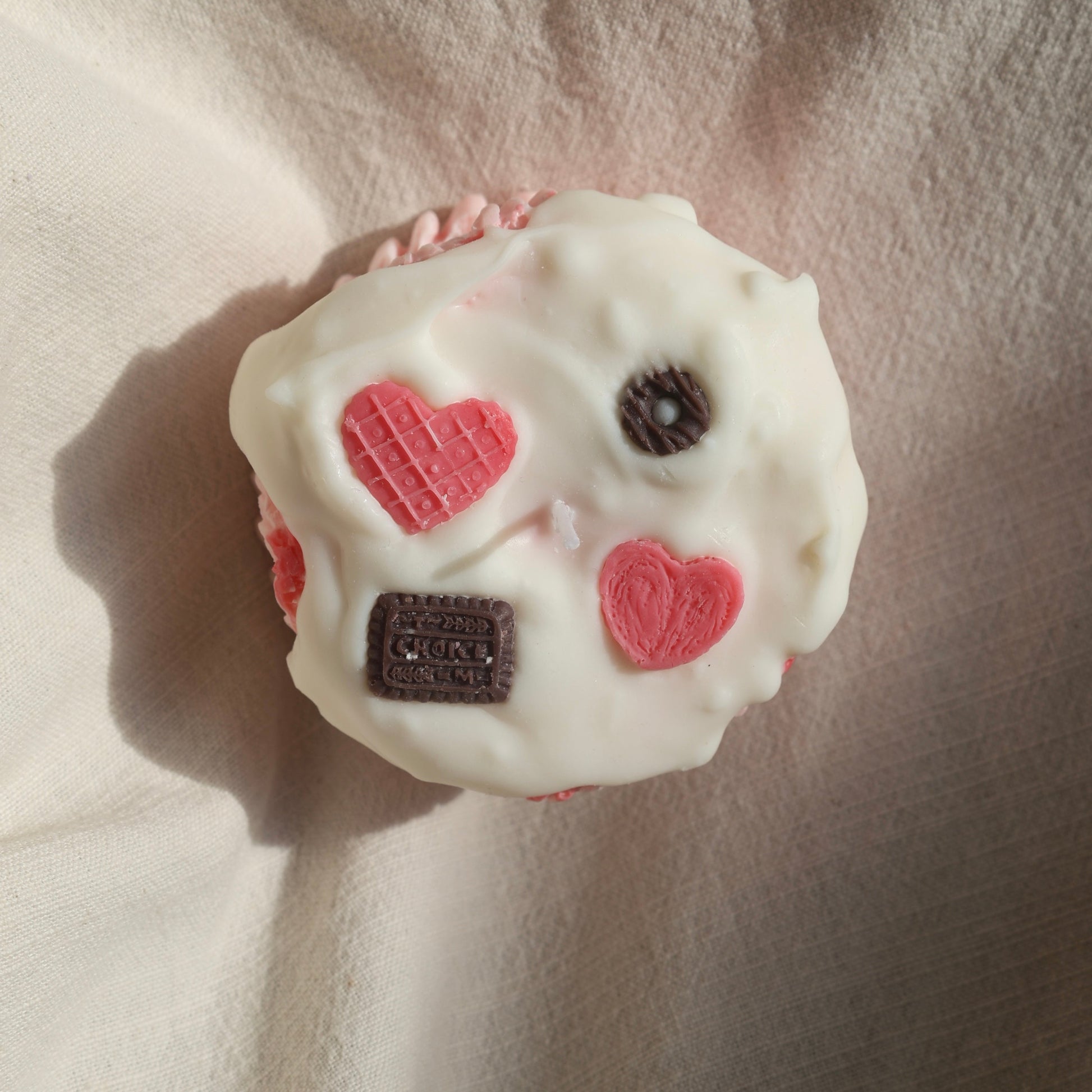Top view of a pink heart-shaped candle with biscuit details by Lily Glow Home Decor