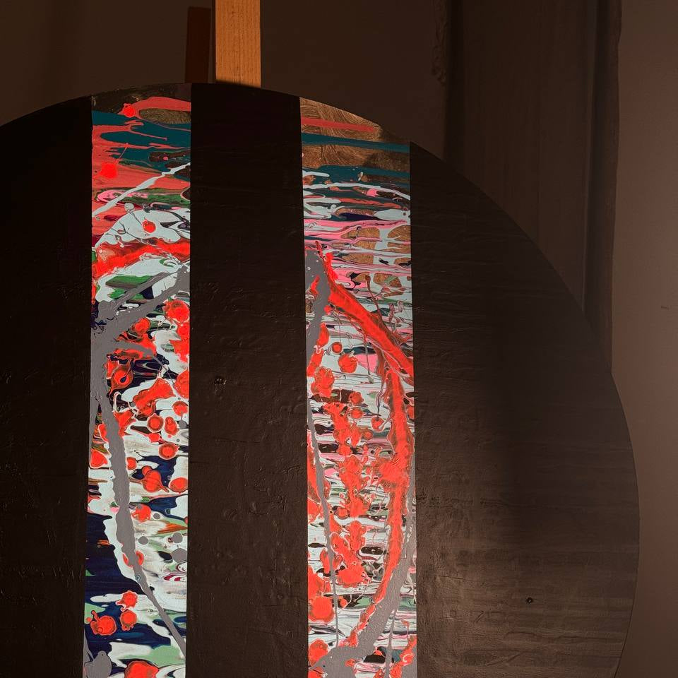Round abstract painting with colorful splashes and black stripes by Lily Glow Home Decor