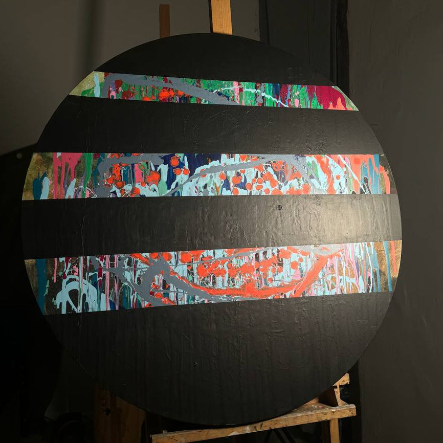 Round abstract painting with colorful splashes and black stripes by Lily Glow Home Decor