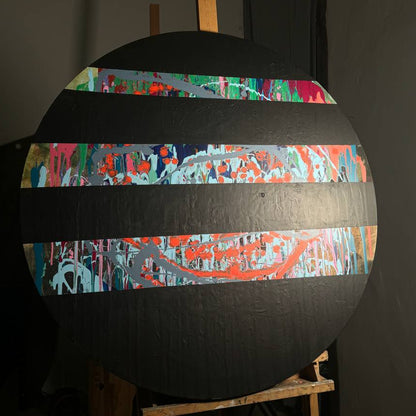 Round abstract painting with colorful splashes and black stripes by Lily Glow Home Decor