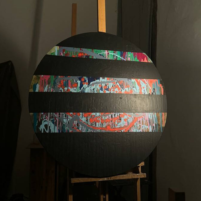 Round abstract painting with colorful splashes and black stripes by Lily Glow Home Decor