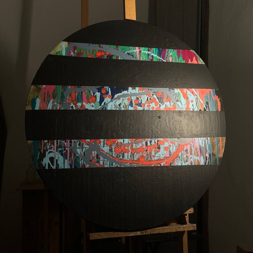 Round abstract painting with colorful splashes and black stripes by Lily Glow Home Decor