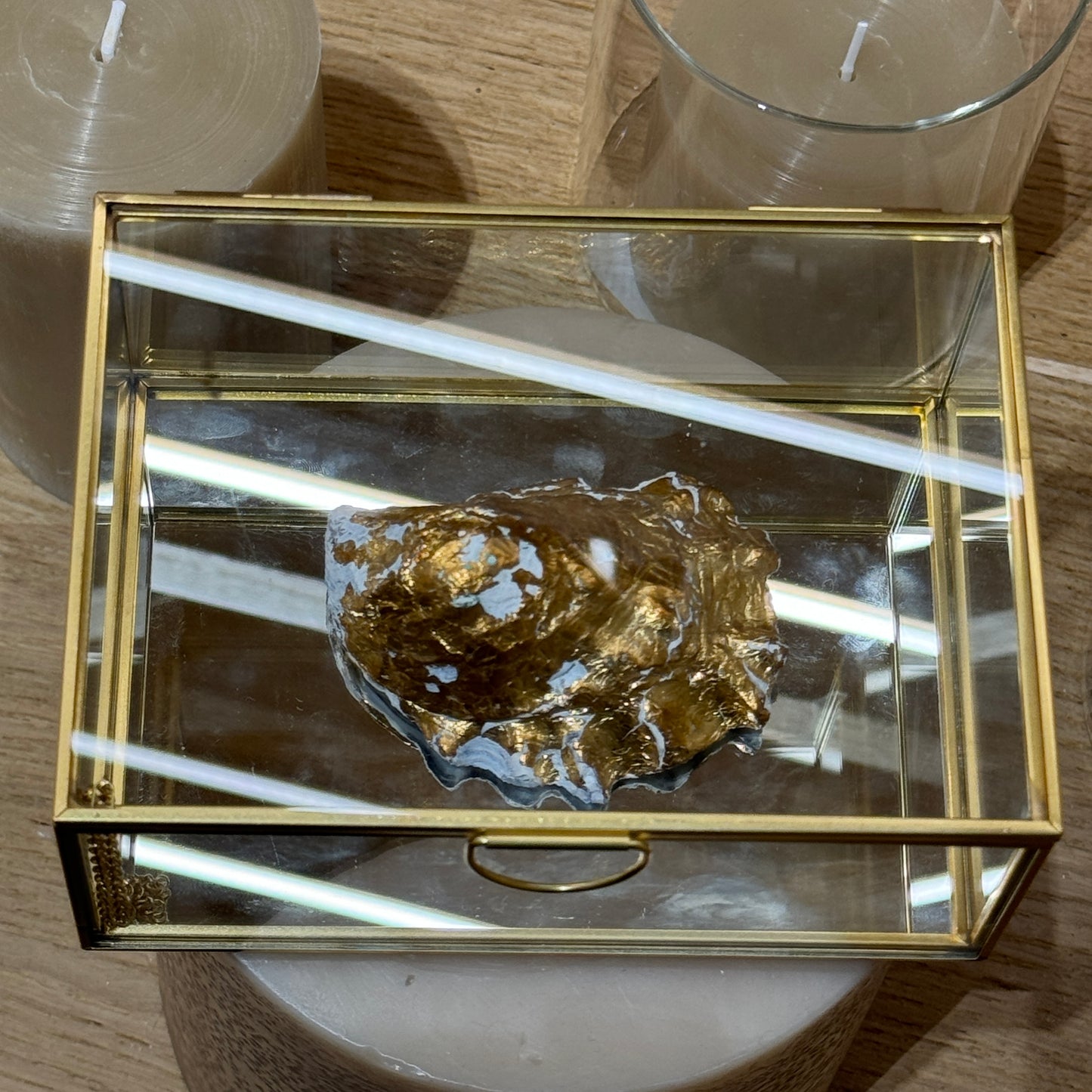 Bottom view of a gold-leafed oyster seashell candle by Lily Glow Home Decor 