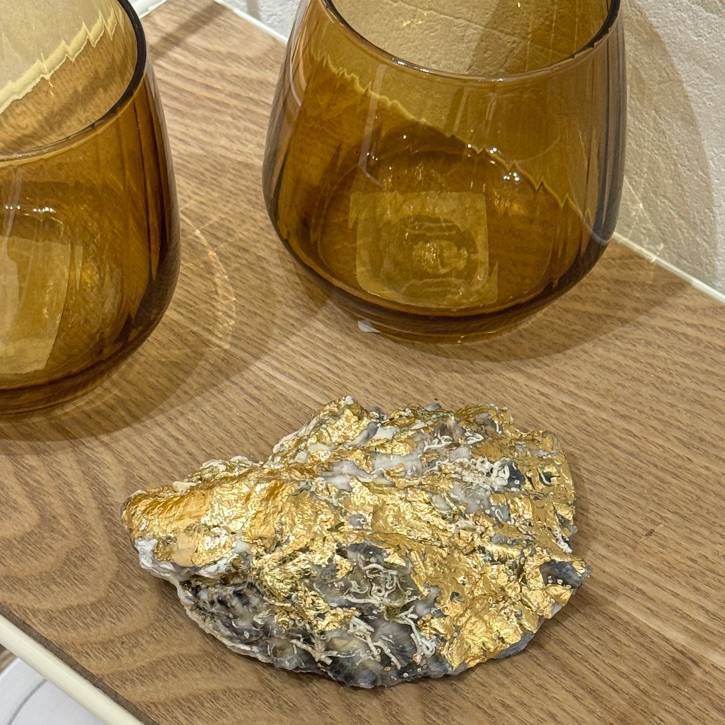 Gold-detailed oyster shell candle by Lily Glow Home Decor shown from the back