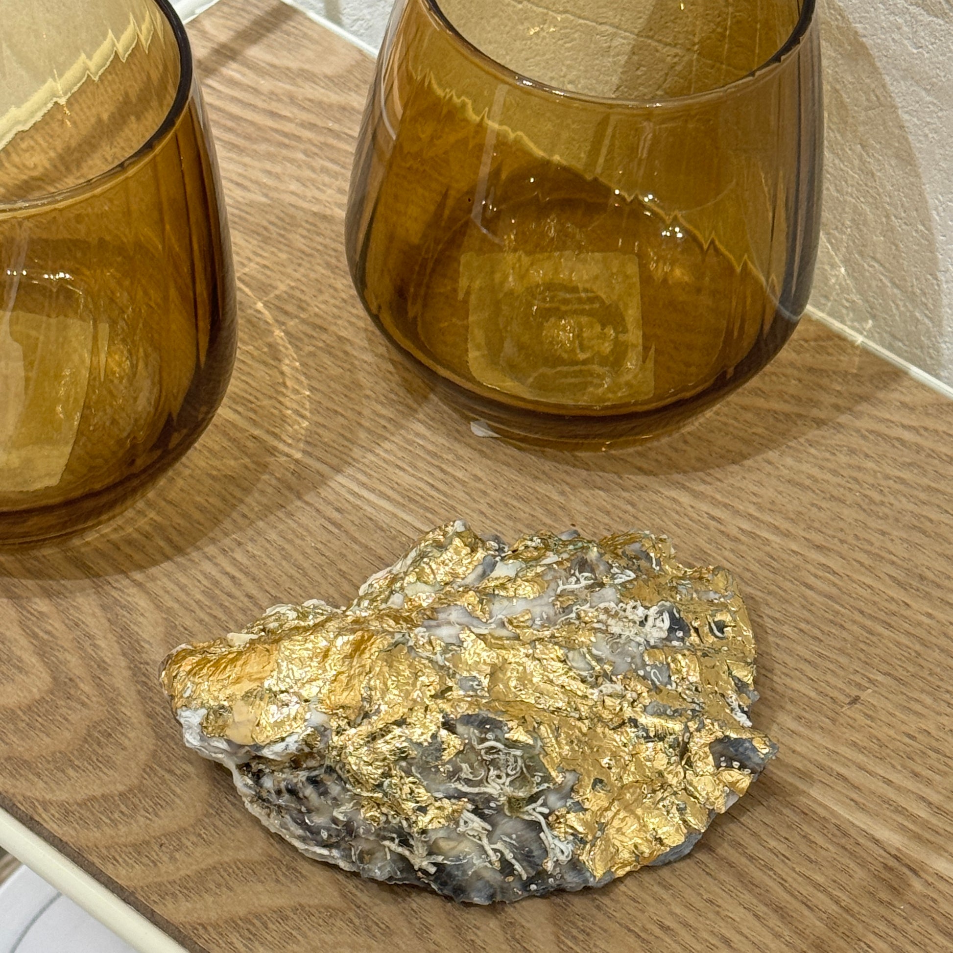 Gold-detailed oyster shell candle by Lily Glow Home Decor shown from the back