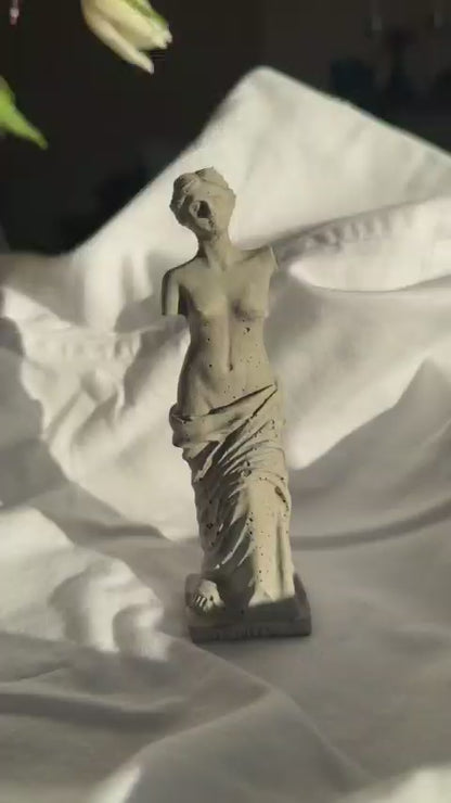 Concrete Venus statue with minimal texture on white fabric background, styled as a decorative element or ring holder by Lily Glow Home Decor